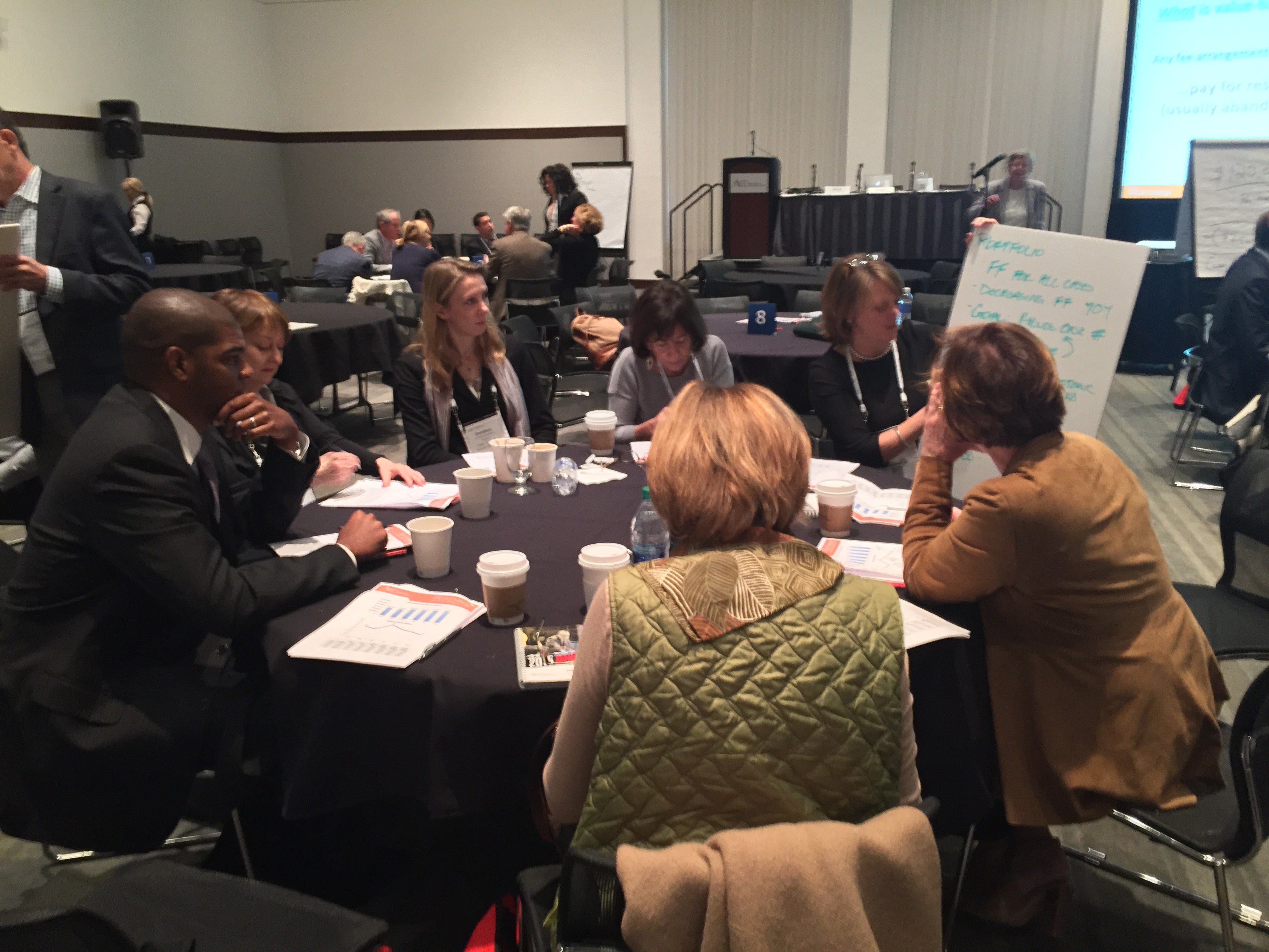 Legal professionals collaborate together around a table at one of ACC's Legal Services Management Workshops.