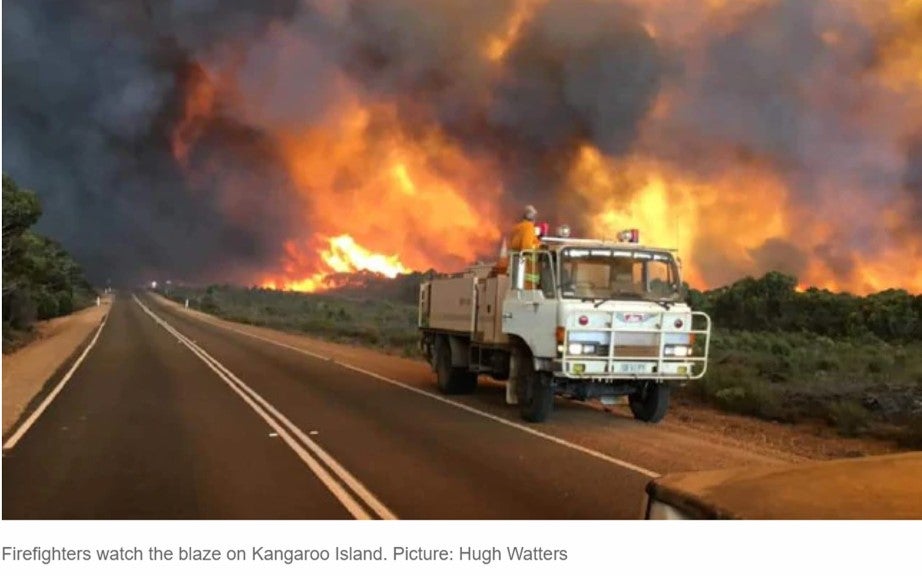 Firefighters watch the blaze on Kangaroo Island