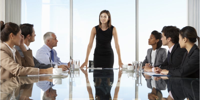 diverse board room meeting led by a women in the center