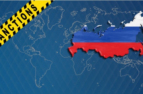 blue world map with Russian flag colors on Russia, and a yellow banner marked Sanctions in black letters across the upper left corner of the map