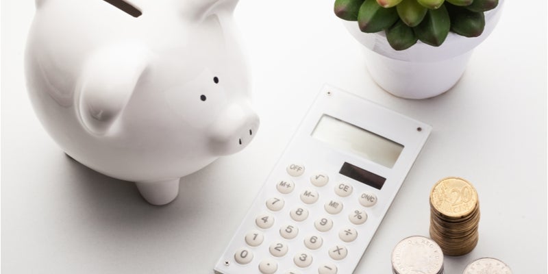 a piggy bank, a calculator, and some coins