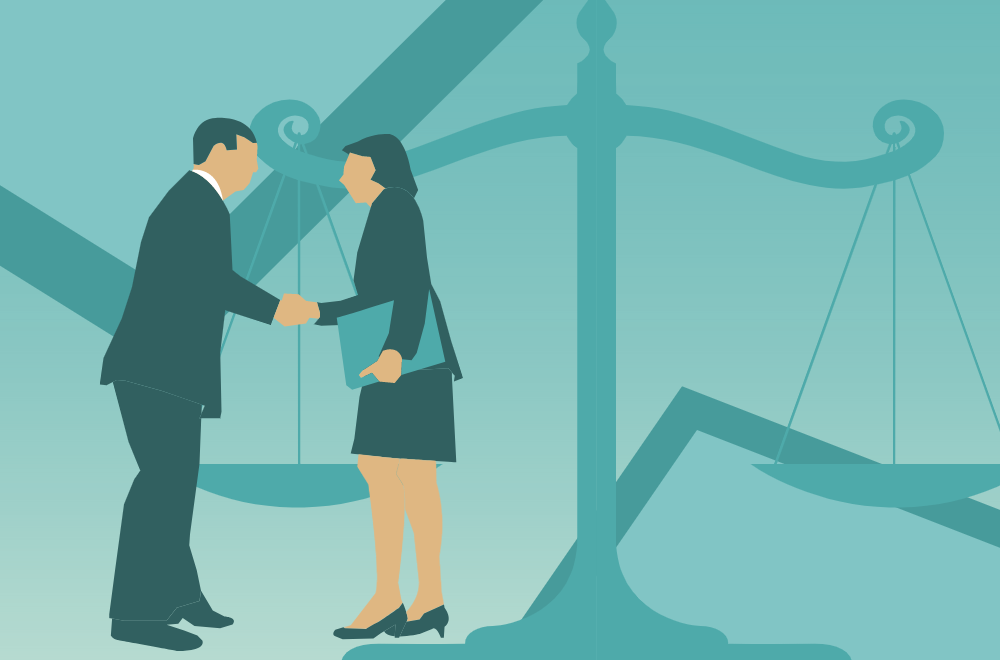 A man and woman shake hands with the scales of justice in the background