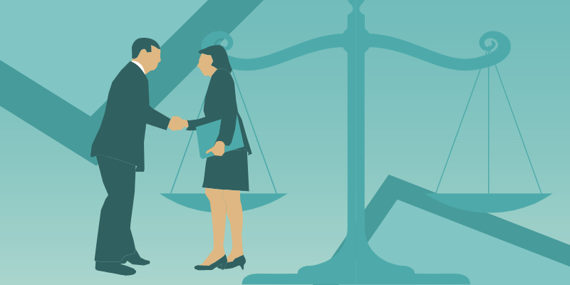 A man and woman shake hands with the scales of justice in the background